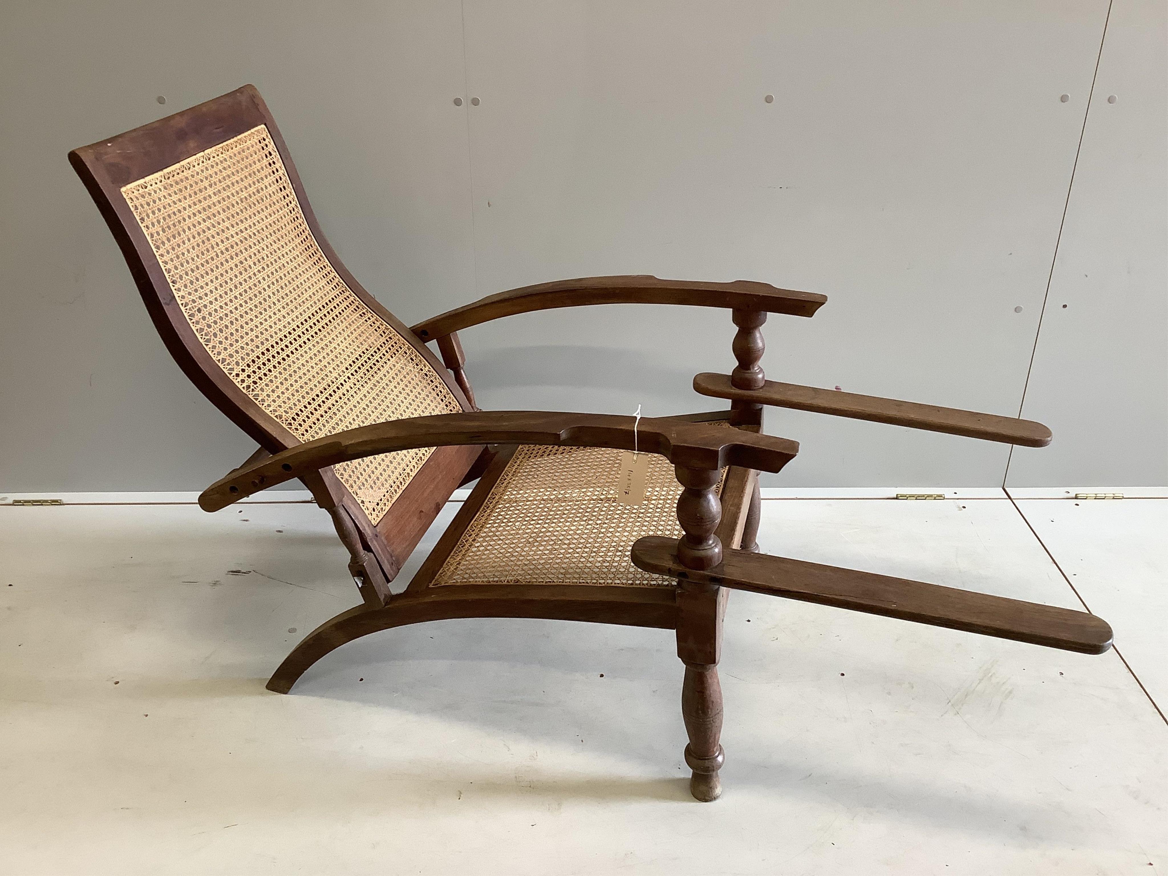 A caned hardwood plantation chair, width 63cm, depth 93cm, height 94cm. Condition - fair